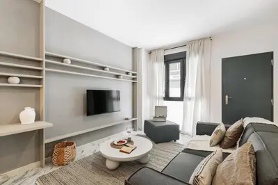 a living room with a couch and a table at Equense - 2 bedrooms in Sant Gervasi in Barcelona