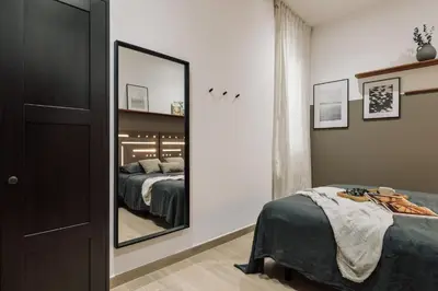 a bedroom with a bed with a book on it at Incahuasi - 3 bedrooms and terrace in Eixample Esquerra in Barcelona