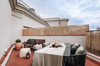 a patio with a table and chairs on a balcony at Geranio - 1 bedroom in Eixample Esquerra in Barcelona
