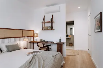 a kitchen with white cabinets and a black oven at Geranio - 1 bedroom in Eixample Esquerra in Barcelona