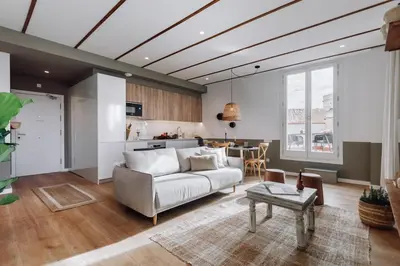 a living room with a couch and a tv at Geranio - 1 bedroom in Eixample Esquerra in Barcelona
