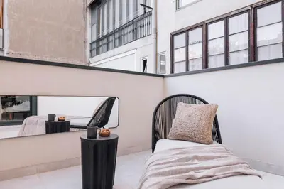 a bedroom with a bed and a mirror at Tibi - 2 bedrooms and office in Eixample Esquerra in Barcelona