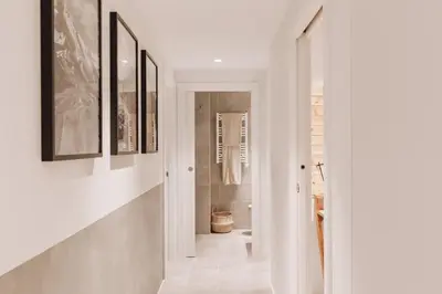 a kitchen with a wooden table with chairs and aendant light at Tibi - 2 bedrooms and office in Eixample Esquerra in Barcelona