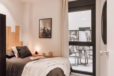 a bathroom with a sink and a toilet and a mirror at Tibi - 2 bedrooms and office in Eixample Esquerra in Barcelona