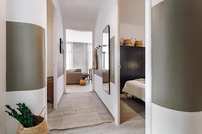 a bedroom with a bed and a table with a lamp at Ziga - 2 bedrooms in Sagrada Família in Barcelona