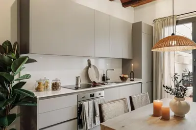 a living room with a tv and a desk with a television at Caliu - 1 bedrooms and terrace in Sagrada Família in Barcelona