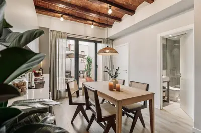 a living room with a couch and a tv at Caliu - 1 bedrooms and terrace in Sagrada Família in Barcelona