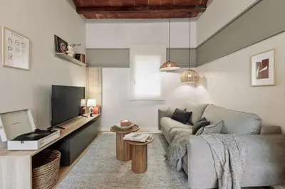 a living room with a couch and an umbrella at Caliu - 1 bedrooms and terrace in Sagrada Família in Barcelona