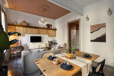a living room with a table and a couch at Batik - 2 bedrooms and terrace in Eixample Dreta in Barcelona
