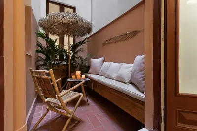 a bedroom with a large bed with a hat on it at Batik - 2 bedrooms and terrace in Eixample Dreta in Barcelona
