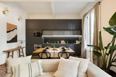 a living room with a couch and a tv at Batik - 2 bedrooms and terrace in Eixample Dreta in Barcelona