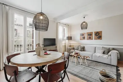 a living room with a table and a couch at Mourene - 3 bedrooms in Eixample Dreta in Barcelona