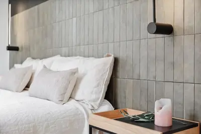 a white bedroom with a bed and a window at Mourene - 3 bedrooms in Eixample Dreta in Barcelona