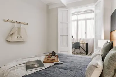 a bedroom with a bed and a desk in it at Mourene - 3 bedrooms in Eixample Dreta in Barcelona