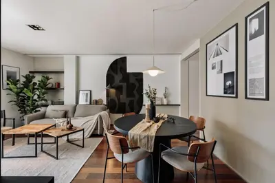 a kitchen and living room with a table and chairs at Lewitt - 1 bedroom in Eixample Dreta in Barcelona