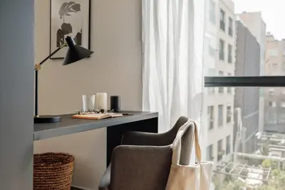 a living room with a table and chairs and a couch at Lewitt - 1 bedroom in Eixample Dreta in Barcelona