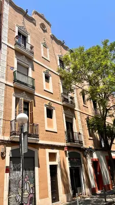 a large brick building with windows and a street light at Charmant appartement à Vila de Gracia Barcelone in Barcelona