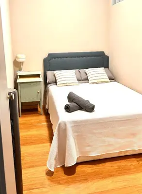 a bedroom with a bed with socks on it at Charmant appartement à Vila de Gracia Barcelone in Barcelona