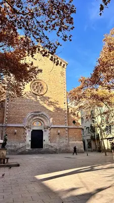 a large brick building with a clock tower at Charmant appartement à Vila de Gracia Barcelone in Barcelona