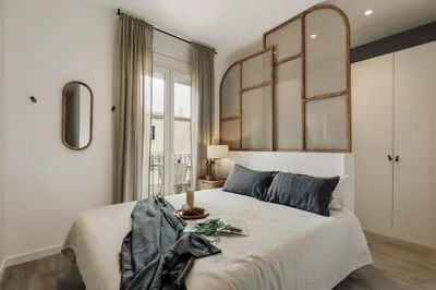 a bedroom with a large bed and a mirror at Caris - 2 bedrooms and balcony in Les Corts in Barcelona