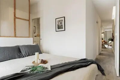 a table with a potted plant and a chandelier at Caris - 2 bedrooms and balcony in Les Corts in Barcelona