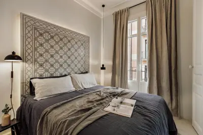 a white bedroom with a bed and a table at Zafiro - 3 bedrooms and balcony in Sants in Barcelona