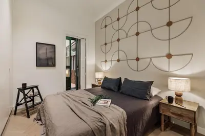 a bedroom with a bed and a chair at Halea - 3 bedrooms w/ terrace in Eixample Esquerra in Barcelona
