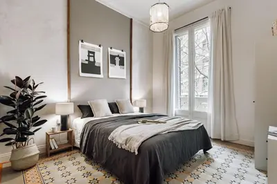 a bedroom with a large bed and a mirror at Tella - 2 bedrooms and office in Eixample Esquerra in Barcelona