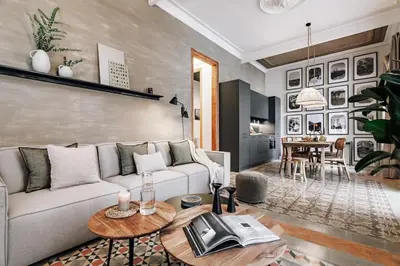 a dining room with a table and a kitchen at Tella - 2 bedrooms and office in Eixample Esquerra in Barcelona