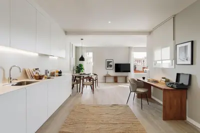 a desk with a laptop and a lamp on it at Calella - 1 bedroom and terrace in Eixample Dreta in Barcelona