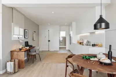 a kitchen and living room with a table and a dining room at Calella - 1 bedroom and terrace in Eixample Dreta in Barcelona