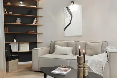 a living room with a couch and a table with candles at Sazos - 2 bedrooms in Sant Antoni in Barcelona