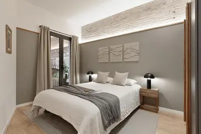 a kitchen and living room with a table and a couch at Sazos - 2 bedrooms in Sant Antoni in Barcelona