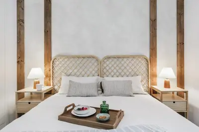 a bedroom with a bed with a tray of food on it at Minori - 2 bedrooms and pool in Poblenou in Barcelona