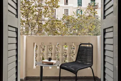 a kitchen with black cabinets and a sink at Etosha - 3 bedrooms and balcony in Eixample Dreta in Barcelona