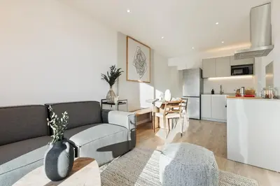 a white bedroom with a large bed and a window at Spiaggia - 1 bedroom and terrace in Sant Gervasi in Barcelona