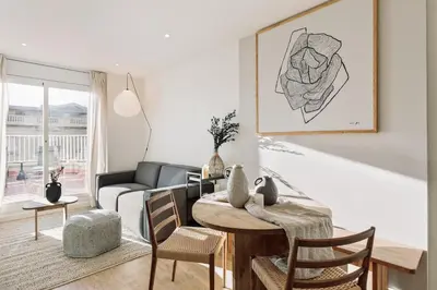 a white bedroom with a bed and a window at Spiaggia - 1 bedroom and terrace in Sant Gervasi in Barcelona