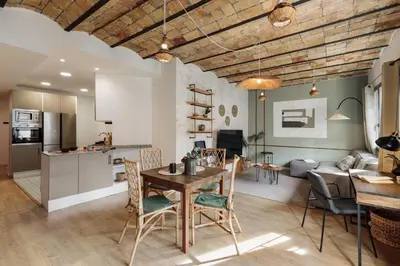 a kitchen and living room with a table and chairs at Kuta - 2 bedrooms and balcony in Sant Gervasi in Barcelona