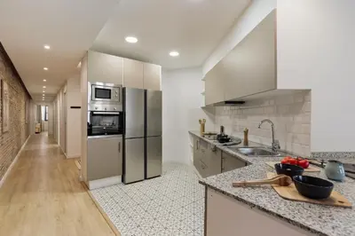a bedroom with a brick wall and a large bed at Kuta - 2 bedrooms and balcony in Sant Gervasi in Barcelona