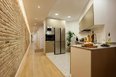 a kitchen with stainless steel appliances and marble counter tops at Kuta - 2 bedrooms and balcony in Sant Gervasi in Barcelona