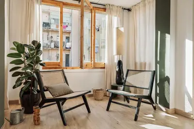 a dining room with a table and a chandelier at Demir - 2 bedrooms and office in Vila de Gràcia in Barcelona