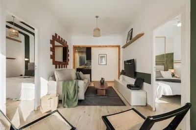 a bedroom with a bed with a large headboard at Demir - 2 bedrooms and office in Vila de Gràcia in Barcelona