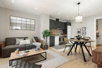 a kitchen and living room with a table and chairs at Ceret - 1 bedroom in Gòtic in Barcelona