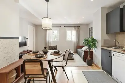 a kitchen and dining room with a table and chairs at Ceret - 1 bedroom in Gòtic in Barcelona