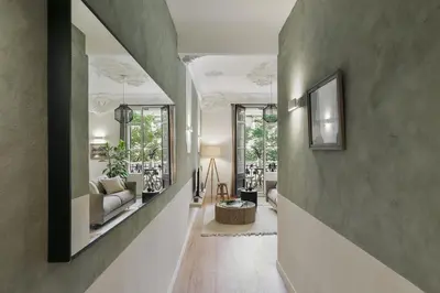 a living room with a couch and a table at Paestum - Studio and balcony in Eixample Esquerra in Barcelona