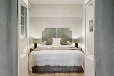 a living room with a couch and a table at Paestum - Studio and balcony in Eixample Esquerra in Barcelona