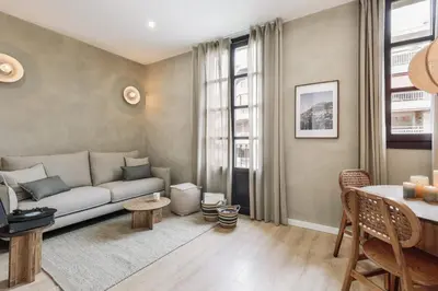 a living room with a couch and a table at Tramonti - 2 bedrooms and terrace in Sant Antoni in Barcelona