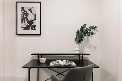 a bedroom with a large bed and a desk at Marce - 3 bedrooms and a terrace in Les Corts in Barcelona