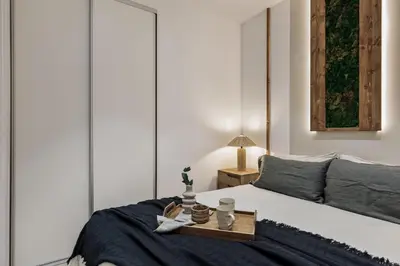 a small bedroom with a bed and a mirror at Belua - 2 bedrooms in Sarrià in Barcelona