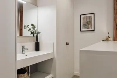 a bedroom with a bed with a mirror and a book at Alaju - 3 bedrooms and balcony in Les Corts in Barcelona